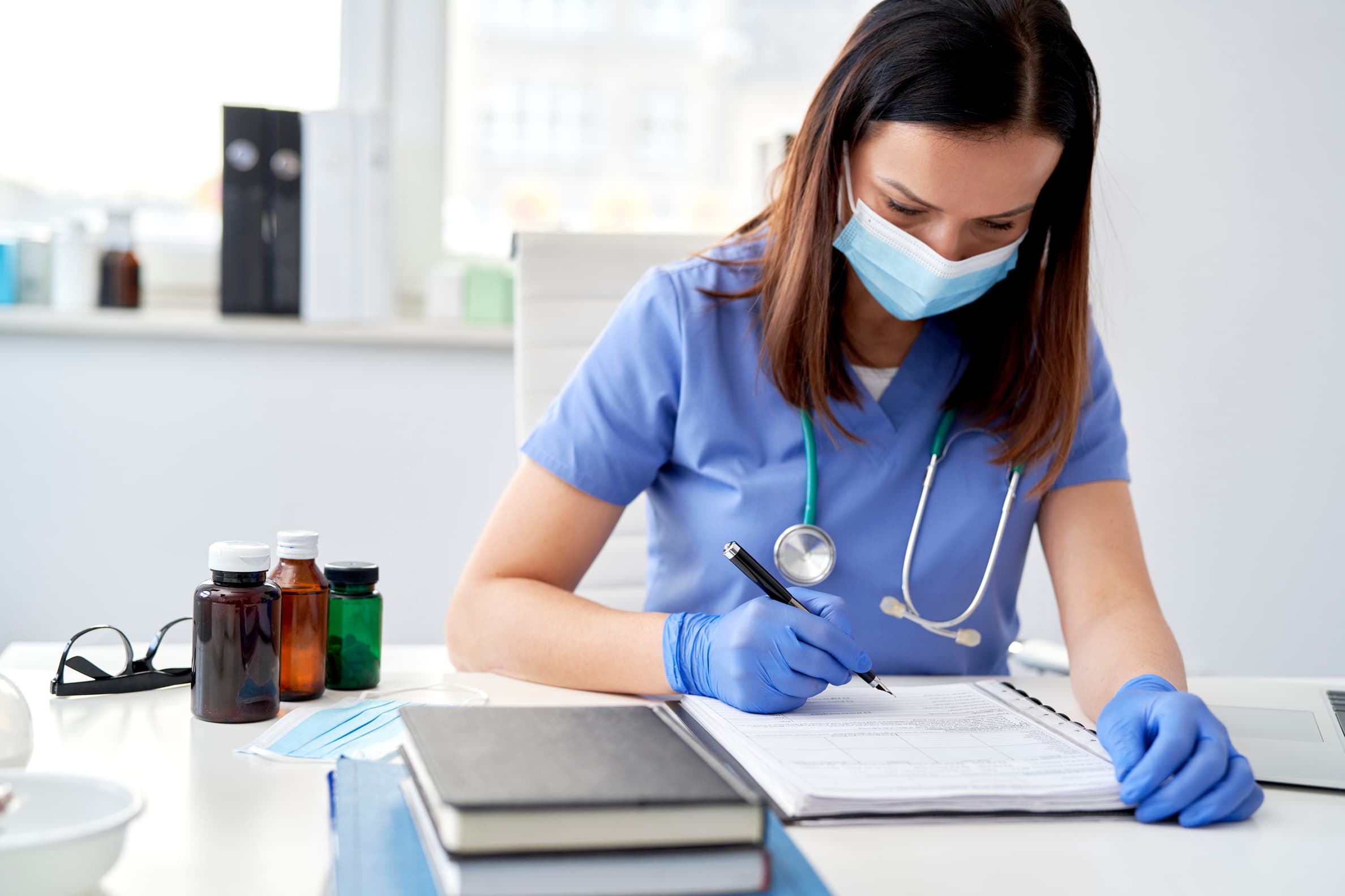 doctor typing on keyboard taking patient notes